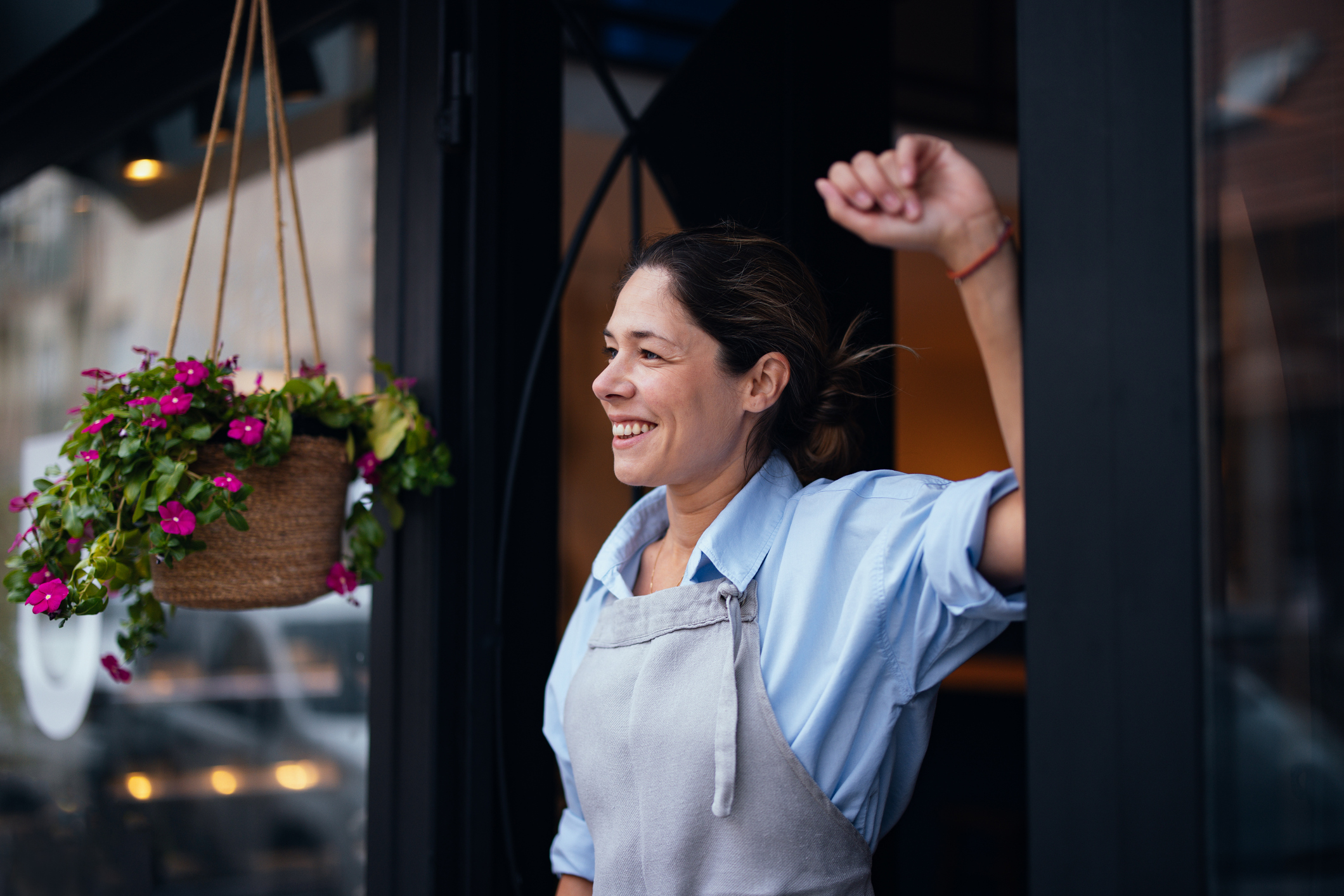 Business owner standing in the doorway of her bakery.